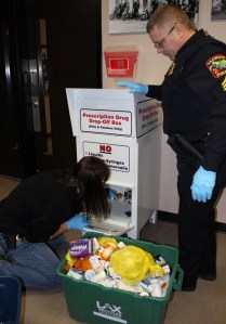 Lt. Avrie Schott and Sgt. Kirk Flatten empty the drug drop box.